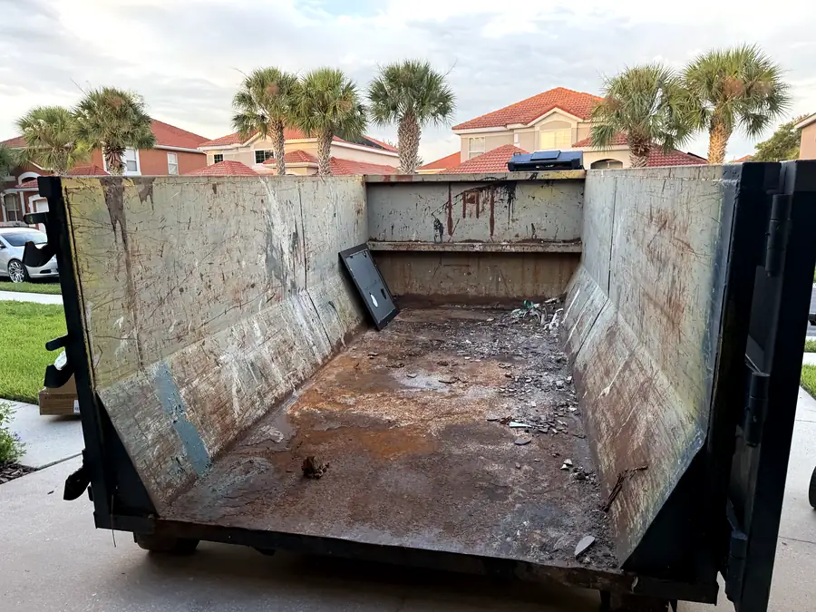 The inside of an empty roll-off can with the rear barn doors swung open