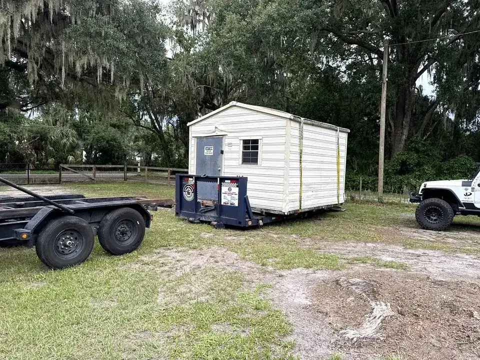 A shed arriving at its new spot on the First Responder Transport trailer