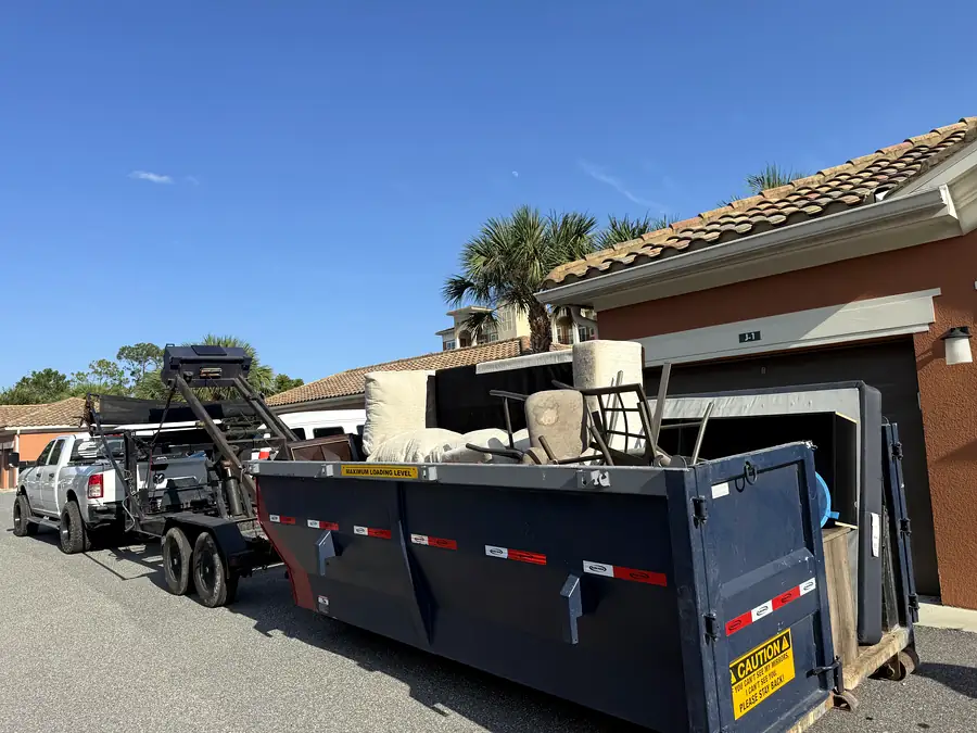 A can on the trailer at a tile-roofed house on a clear day