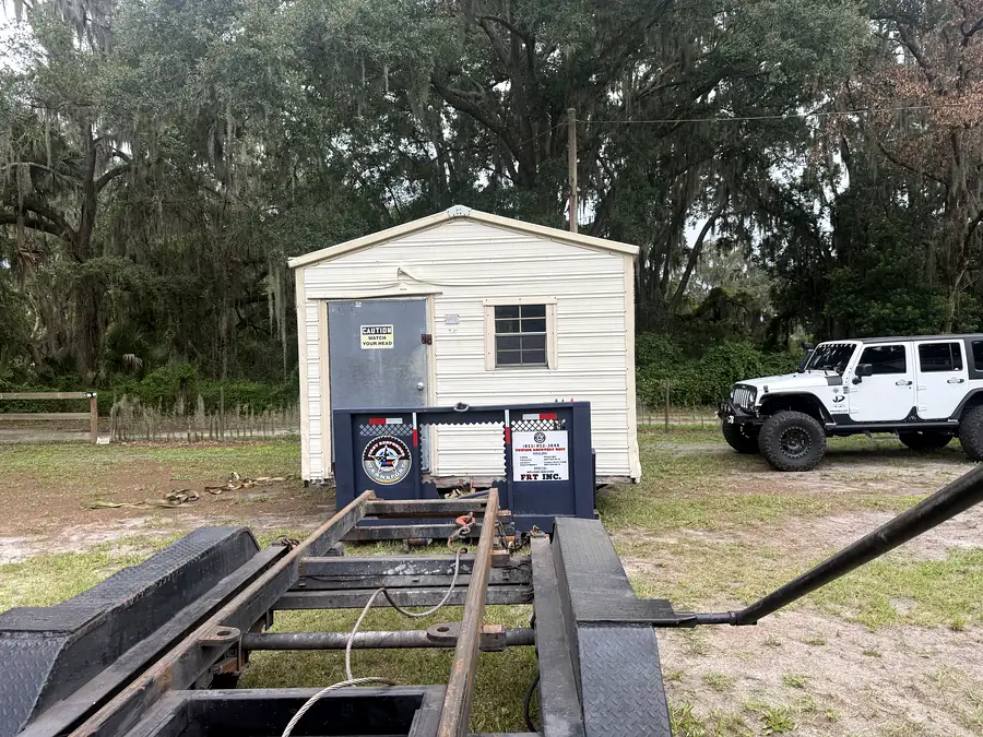 A shed set down on rails at its new site